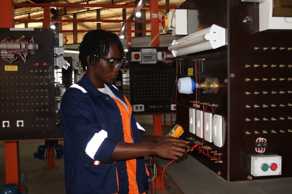 A trainee experiments on an electrical installation in Yekepa